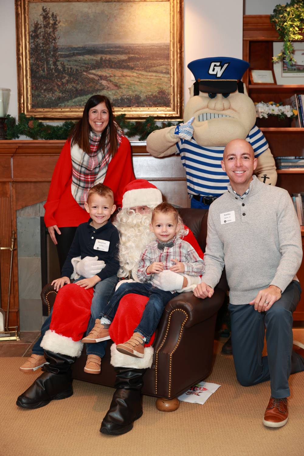 A family of four with Santa & Louie at the event.